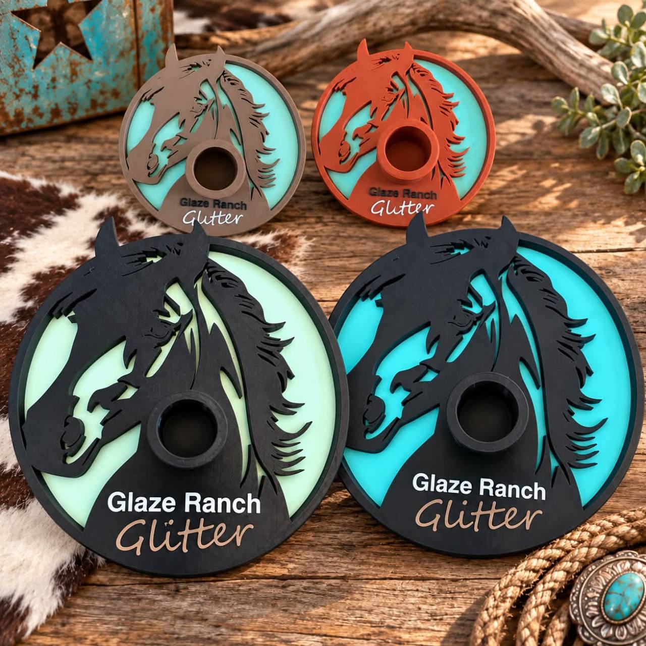 Four completed Glaze Ranch Glitter branded tumbler drying bases with horse artwork
